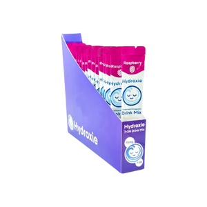 Purple and pink retail display box for Hydroxie drink mix packets.