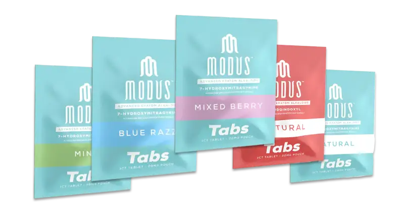 Multiple packages of Modus brand tabs in blue and coral-colored designs arranged in a staggered formation.