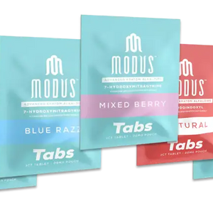 Multiple packages of Modus brand tabs in blue and coral-colored designs arranged in a staggered formation.