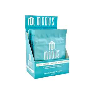 Teal-colored product display box containing Modus brand packets.