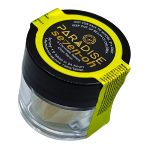 Glass jar with black lid and yellow label containing Paradise Selection cannabis product.